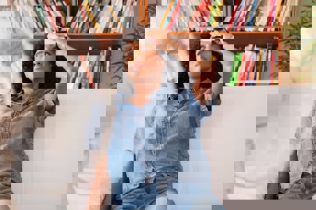 woman wiping sweat from forehead